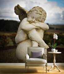 Скульптура спящего ангела на шаре