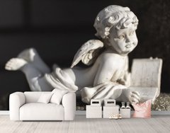 Скульптура лежащего ангелочка