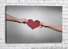 Две руки дарят бумажное сердце