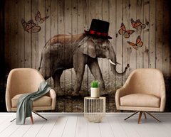 Elefant în pălărie de cilindă și fluturi pe fundal de scândură