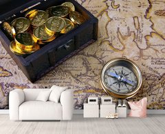 Сундук с монетами и латунный компас на фоне карты