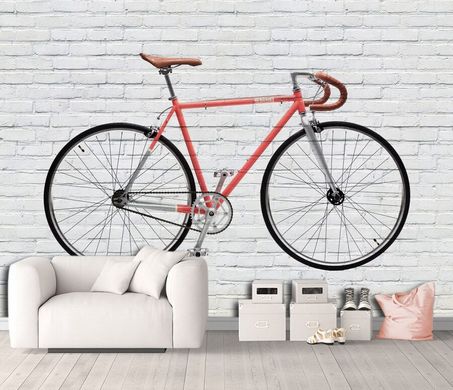 Велосипед на белой кирпичной стене